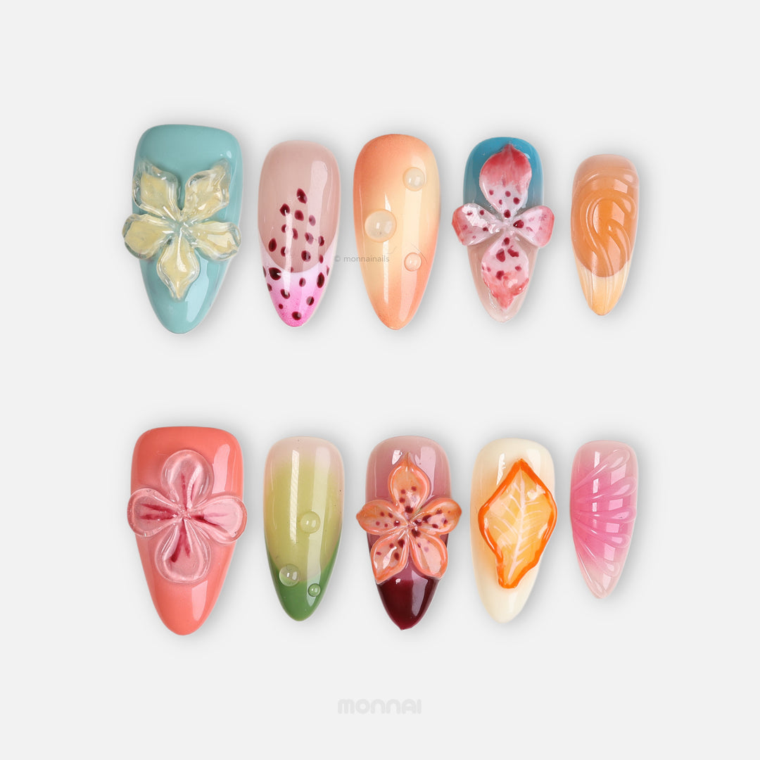 Fruit Garden press-on nails laid out in a botanical collage with 3D florals, water droplets, and coral, sage, pink, and peach tones.