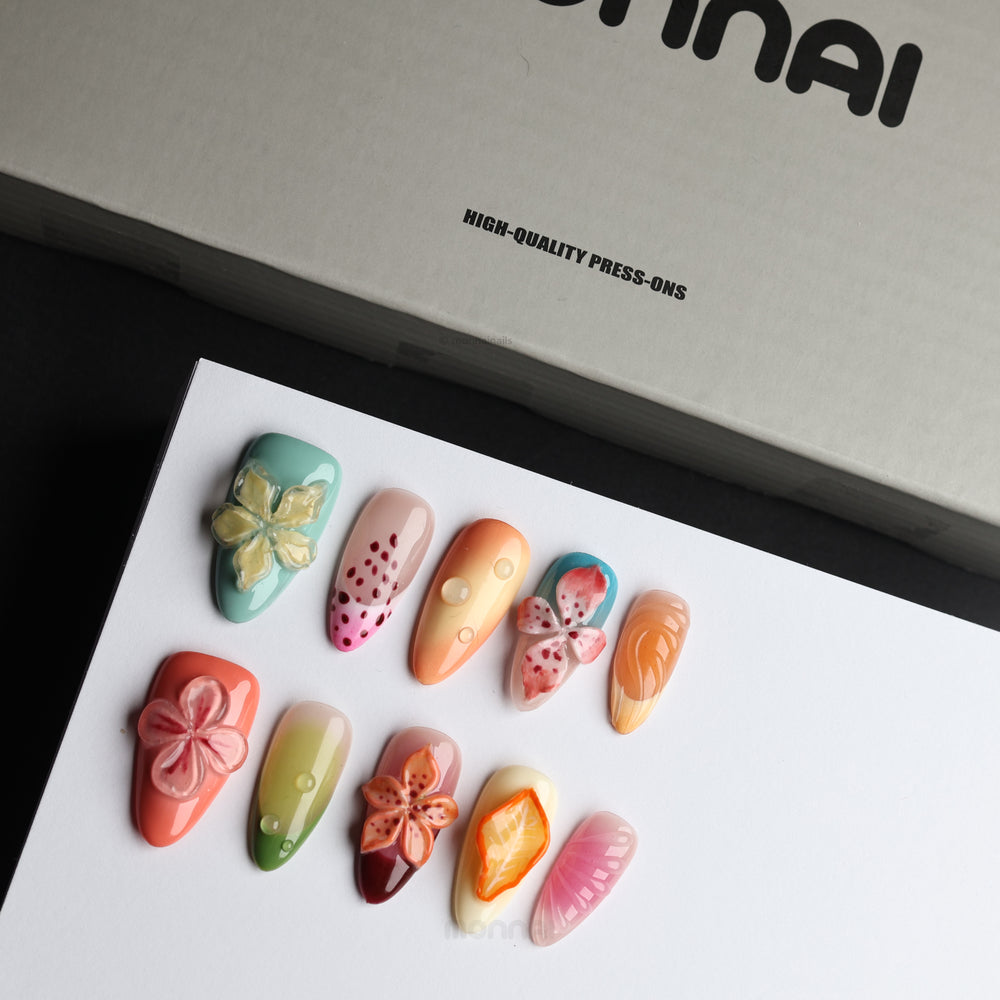 Fruit Garden press-on nails laid out in a botanical collage with 3D florals, sage green, coral and milky white gloss.