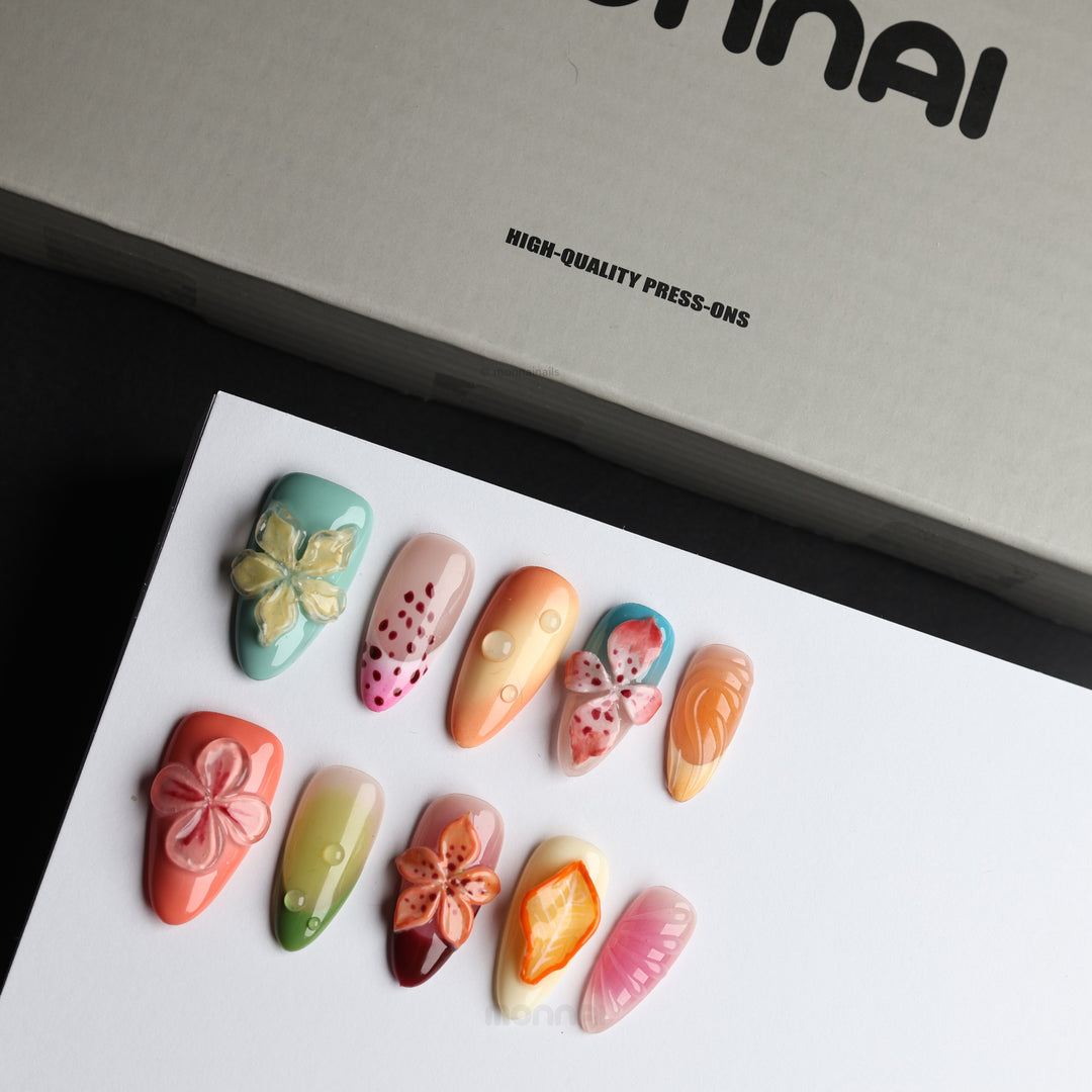 Fruit Garden press-on nails laid out in a botanical collage with 3D florals, sage green, coral and milky white gloss.