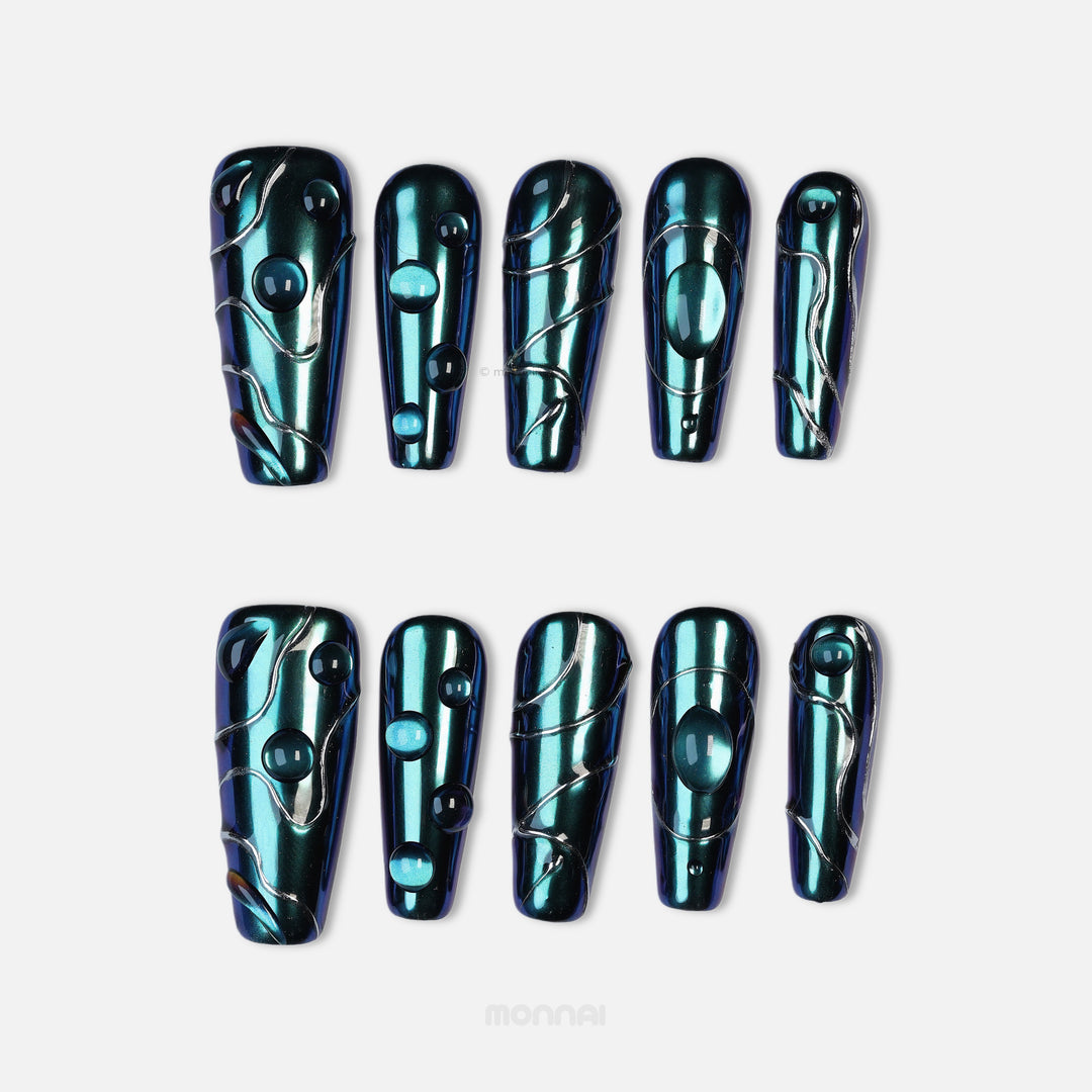 Galactic Shift press-on nails laid out in teal chrome with glossy raised details and metallic line accents