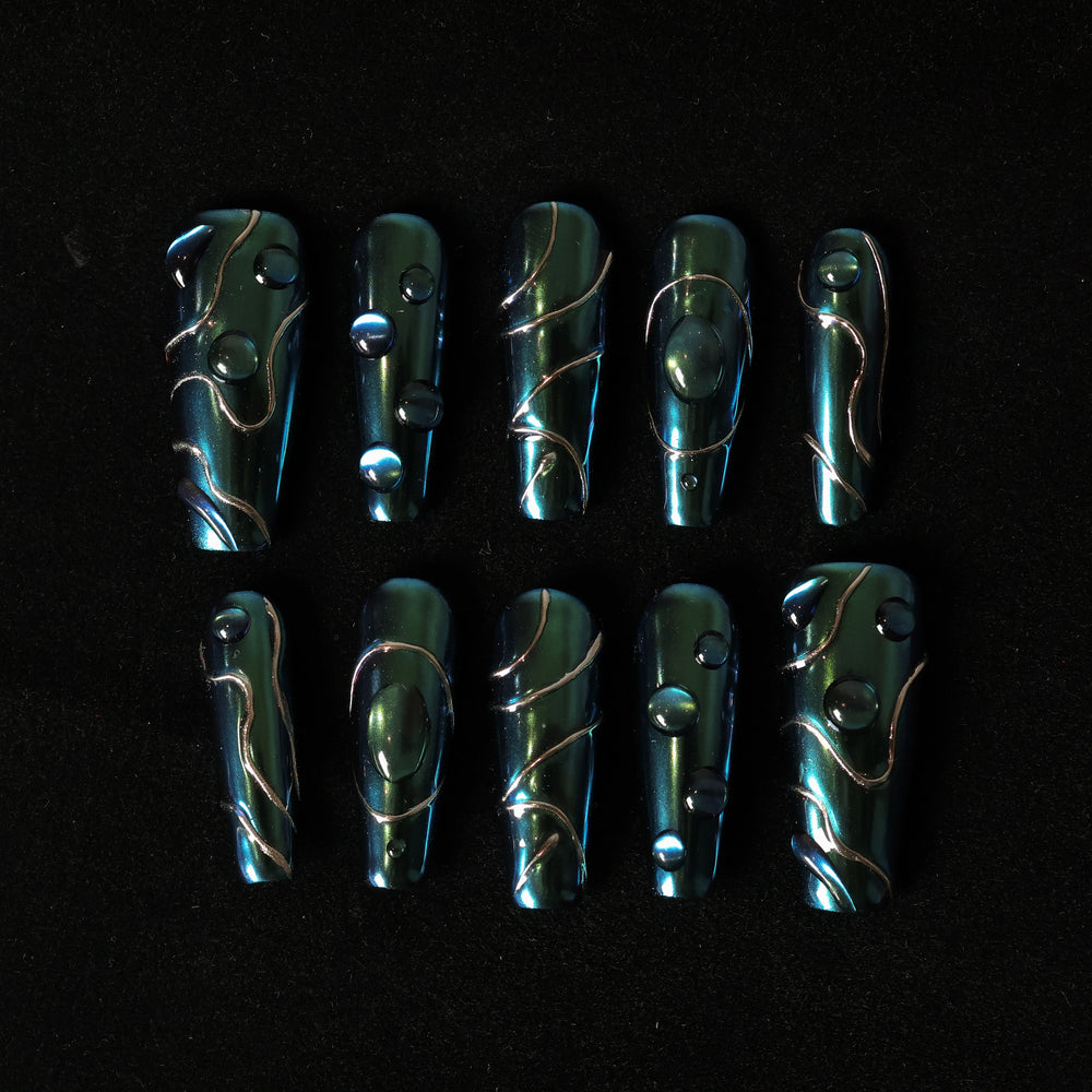 Galactic Shift press-on nails laid out with color-shifting teal chrome, glossy raised details, and metallic lines