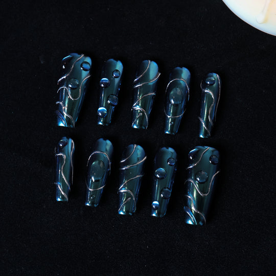 Galactic Shift press-on nails laid out in teal chrome with glossy raised details and fine metallic lines