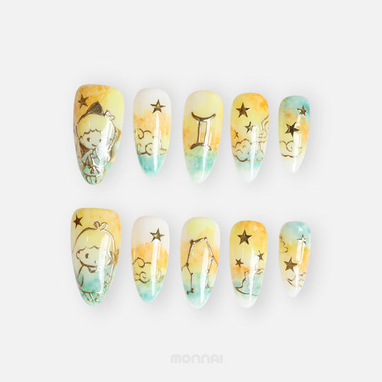  Gemini press on nails from the Zodiac Collection, featuring soft yellow and aqua tones, twin motifs, golden stars and constellation details.