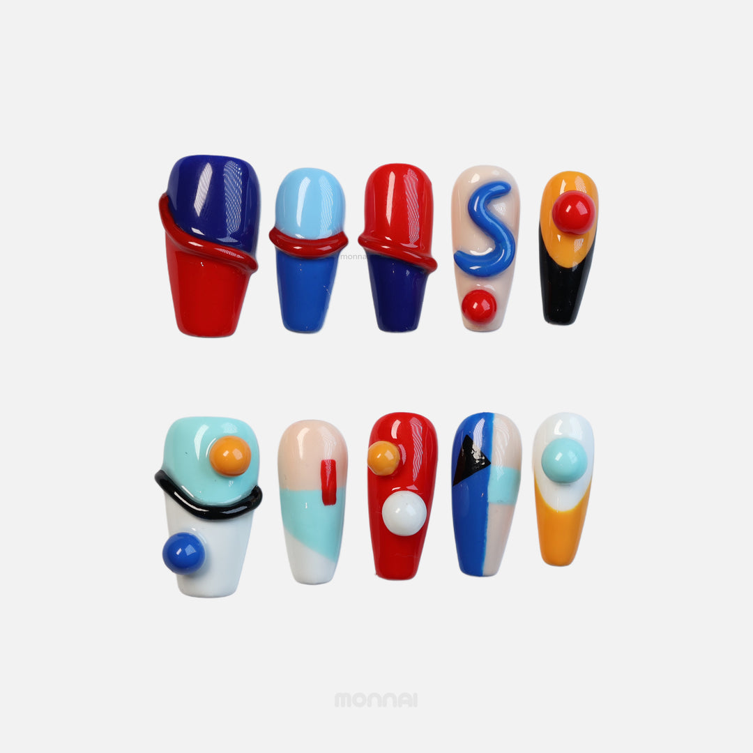Geo Pop press-on nails with glossy abstract color blocking in red, blue, yellow and cream