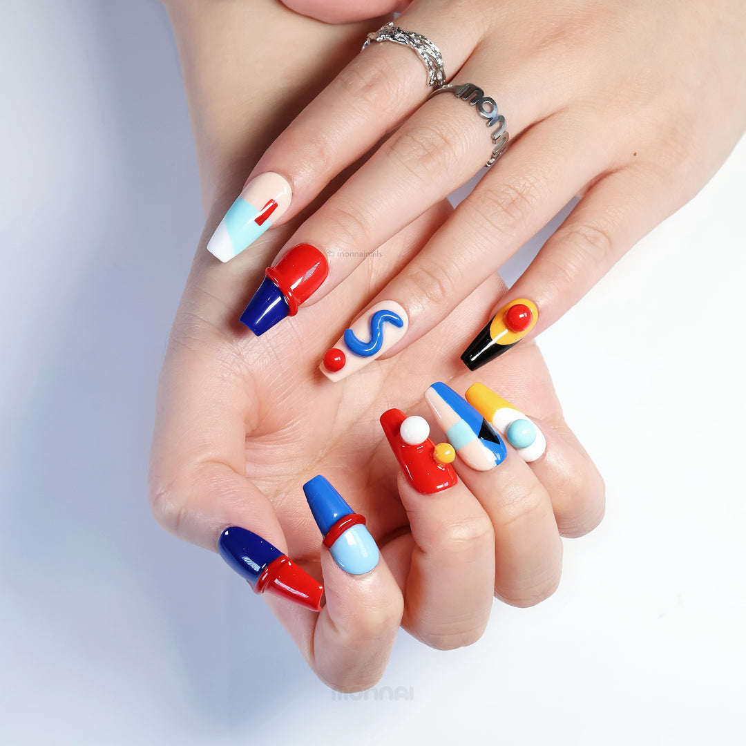 Geo Pop press-on nails on hands with vivid color blocking, glossy sculpted details, and playful abstract shapes