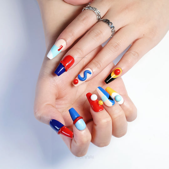 Geo Pop press-on nails on hands with vivid color blocking, glossy sculpted details, and playful abstract shapes