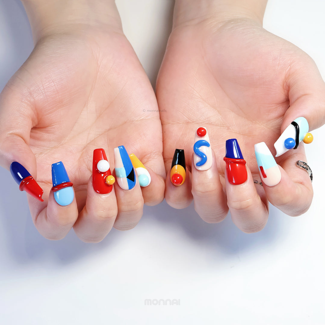 Geo Pop press-on nails on hands, with vivid color blocking and glossy sculpted abstract shapes.