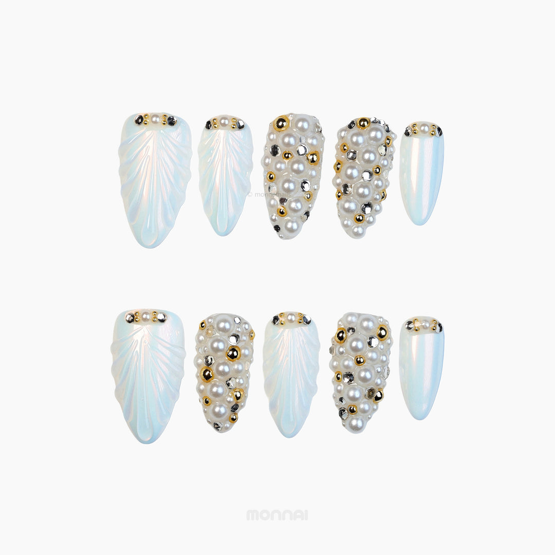 Gilded Pearls press-on nails shown in a set with milky iridescent shells, pearl clusters, and gold crystal accents.