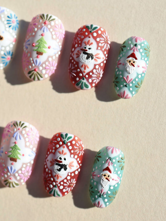 Ginger Cookie Christmas-themed press-on nails laid out with 3D gingerbread, snowman and Santa motifs