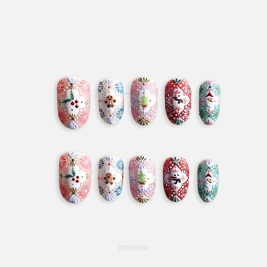 Ginger Cookie Christmas-themed press-on nails shown laid out, with embossed folk art patterns and 3D gingerbread, tree, snowman, Santa motifs.