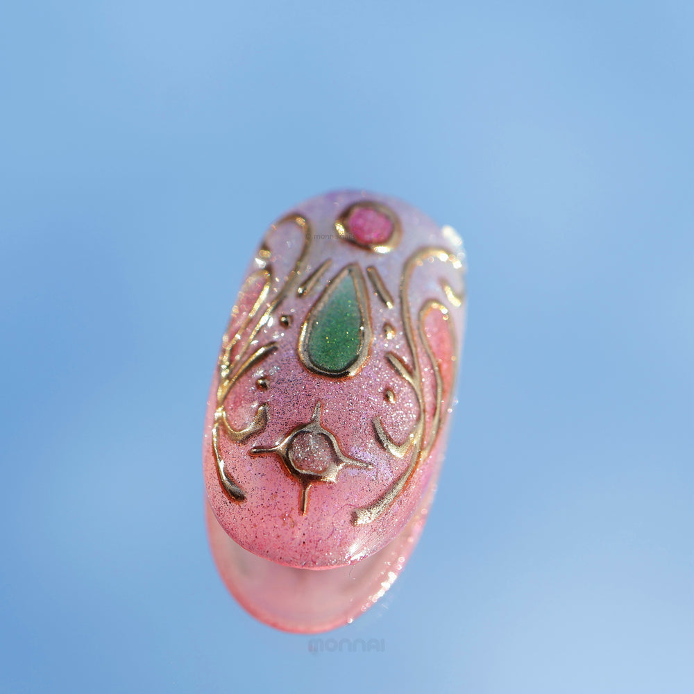 Girl's Cat press-on nails close-up, pink cat eye shimmer with gold outlines and a green teardrop accent, sweet and playful.