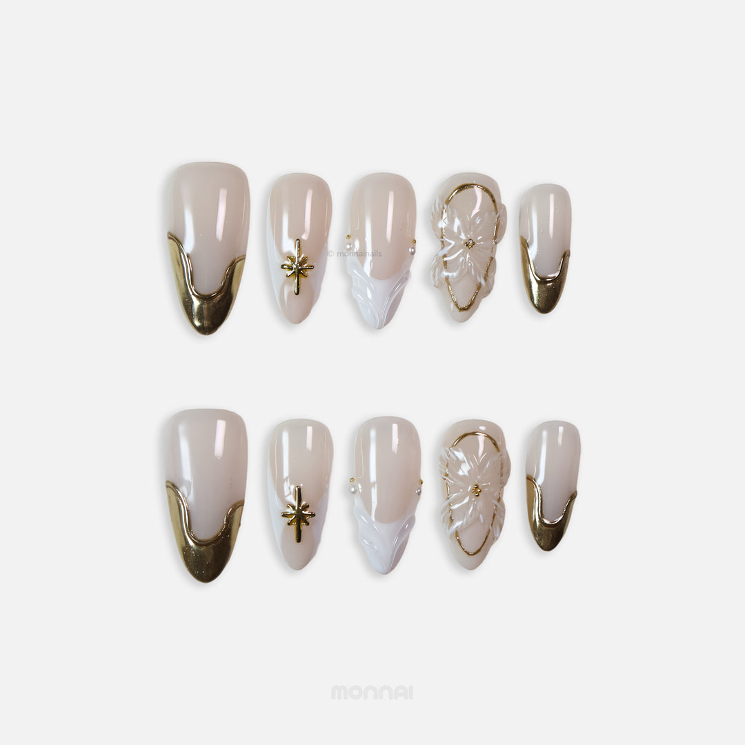Golden Veil press-on nails set with milky nude base, gold chrome tips, star charm, floral 3D accent