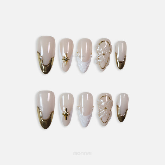 Golden Veil press-on nails set with milky nude base, gold chrome tips, star charm, floral 3D accent