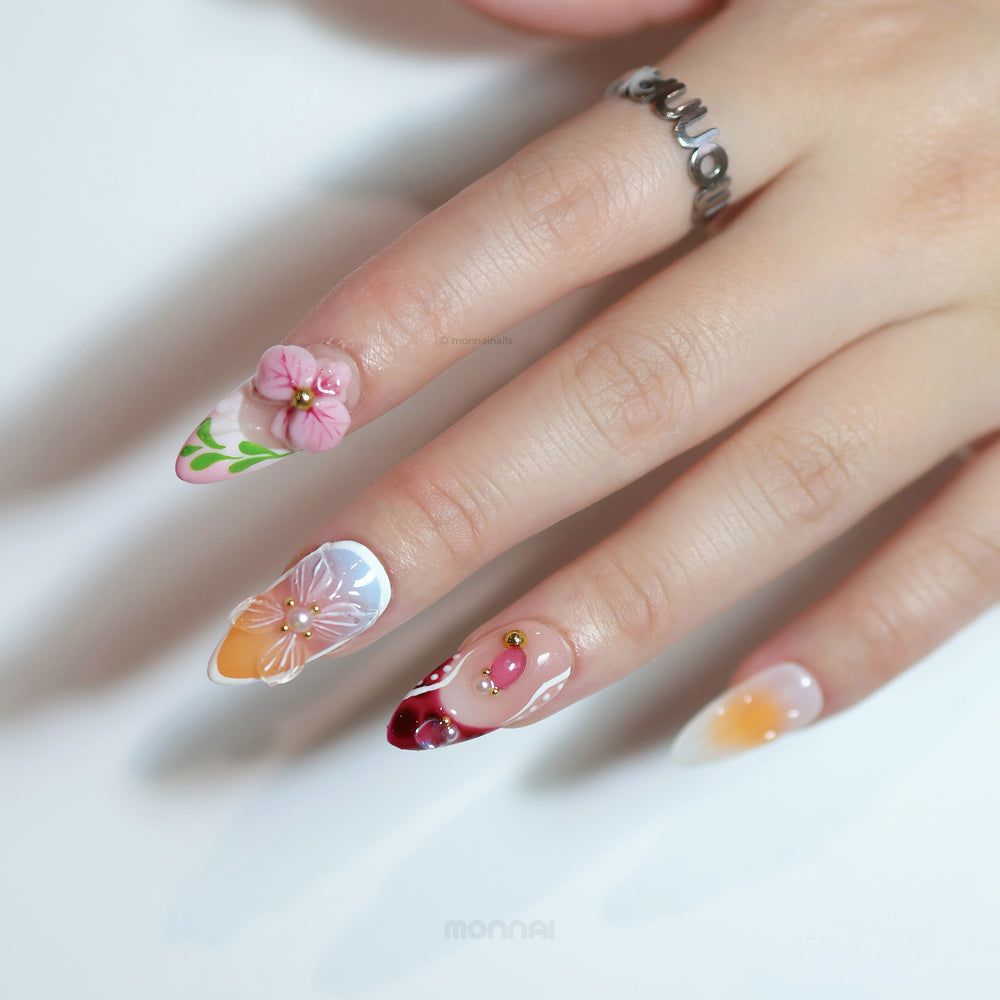 Grace press-on nails with romantic vintage florals, hand-painted flowers, soft nude tones, and gem accents on hand