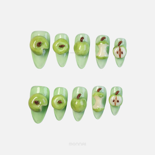 Green Apple press-on nails laid out in a playful 3D apple theme with glossy green sculpted details and bitten slices
