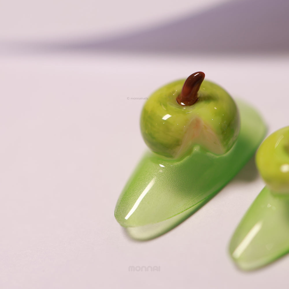 Green Apple press-on nails close-up with glossy 3D apple detail and soft green base