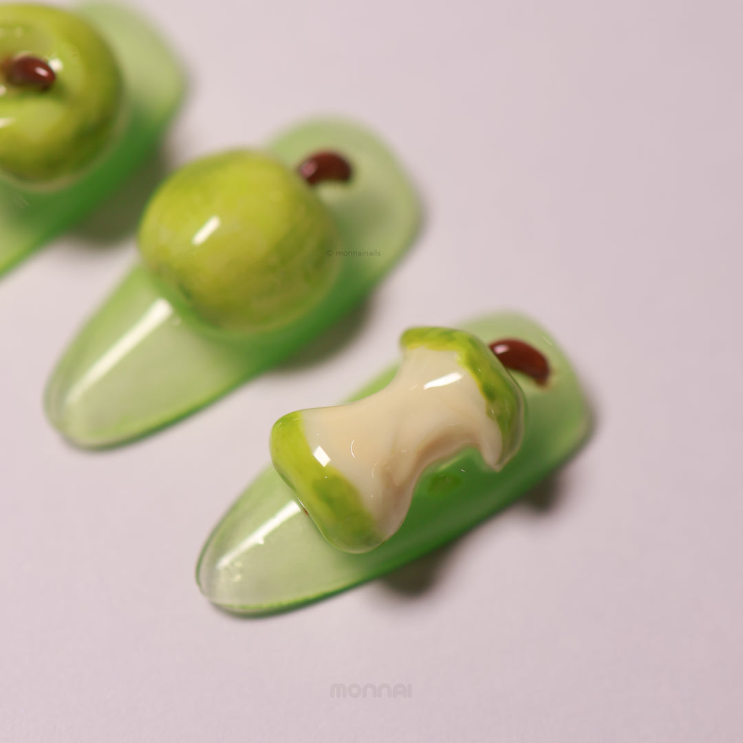 Green Apple press-on nails with glossy 3D sculpted apples, including a bitten nail detail and soft green base