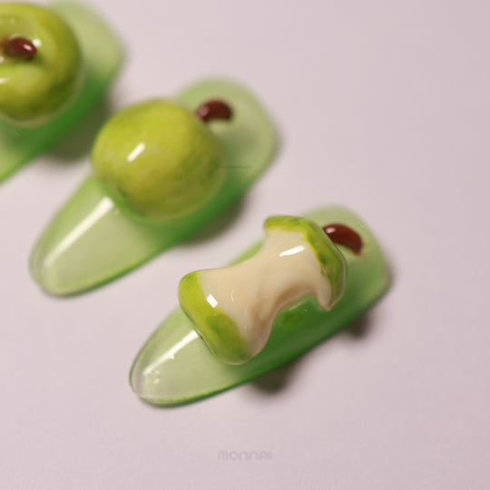 Green Apple press-on nails with glossy 3D sculpted apples, including a bitten nail detail and soft green base