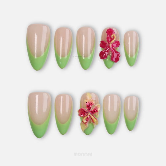 Green Fantasy press-on nails with nude pink bases, soft green French tips, and 3D floral accents.
