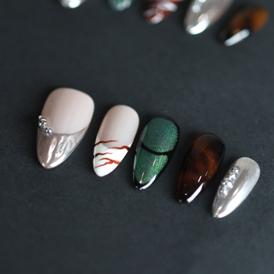 Green Light press-on nails with green cat-eye, amber tortoiseshell and silver chrome on a nude base
