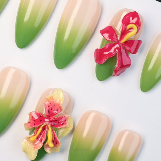 Green Sprout press-on nails with sheer nude base, green ombré fade and 3D orchid details