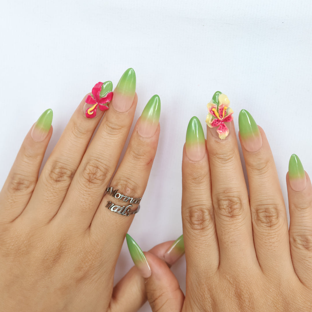 Green Sprout press-on nails shown worn on hands, with green ombré and 3D orchid details in a polished tropical floral style.