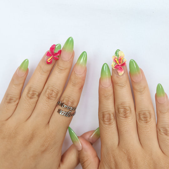 Green Sprout press-on nails shown worn on hands, with green ombré and 3D orchid details in a polished tropical floral style.