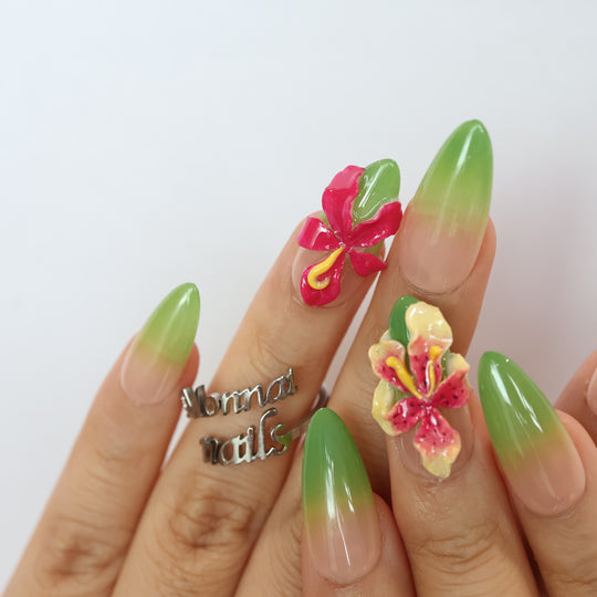 Green Sprout press-on nails on hand, sheer nude with green ombré and hand-sculpted floral 3D orchid details