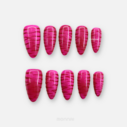 Hot Pink press-on nails laid out in two rows with shimmering zebra texture and glossy finish