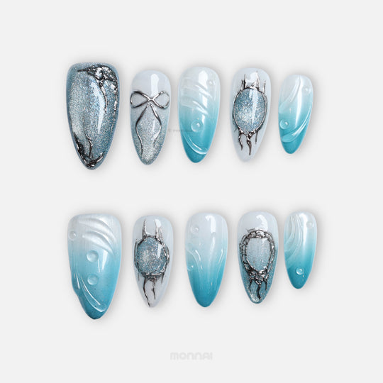 Icy Bubble press-on nails with blue ombré, silver shimmer, and chrome details shown in a laid-out set