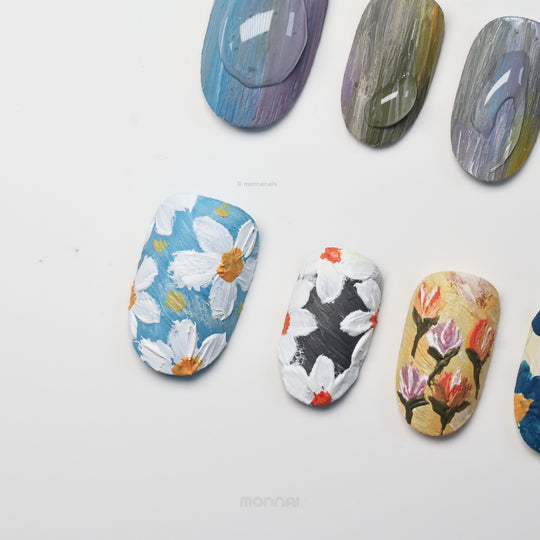 Impressionist Garden press-on nails laid out with raised floral brushstrokes and textured matte canvas-like art
