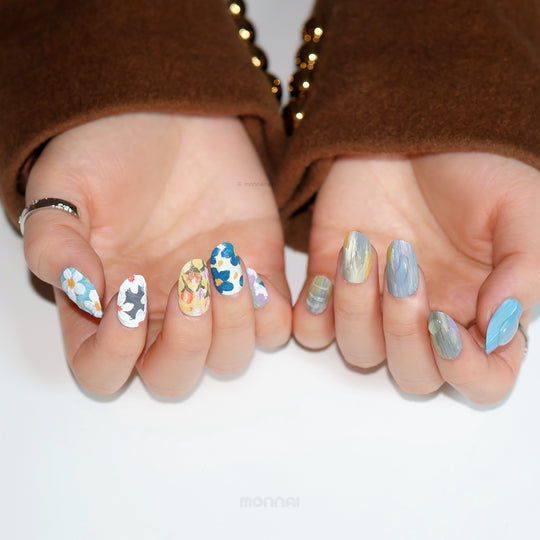 Impressionist Garden press-on nails worn on hands, with layered floral brushstrokes and textured matte finishes.