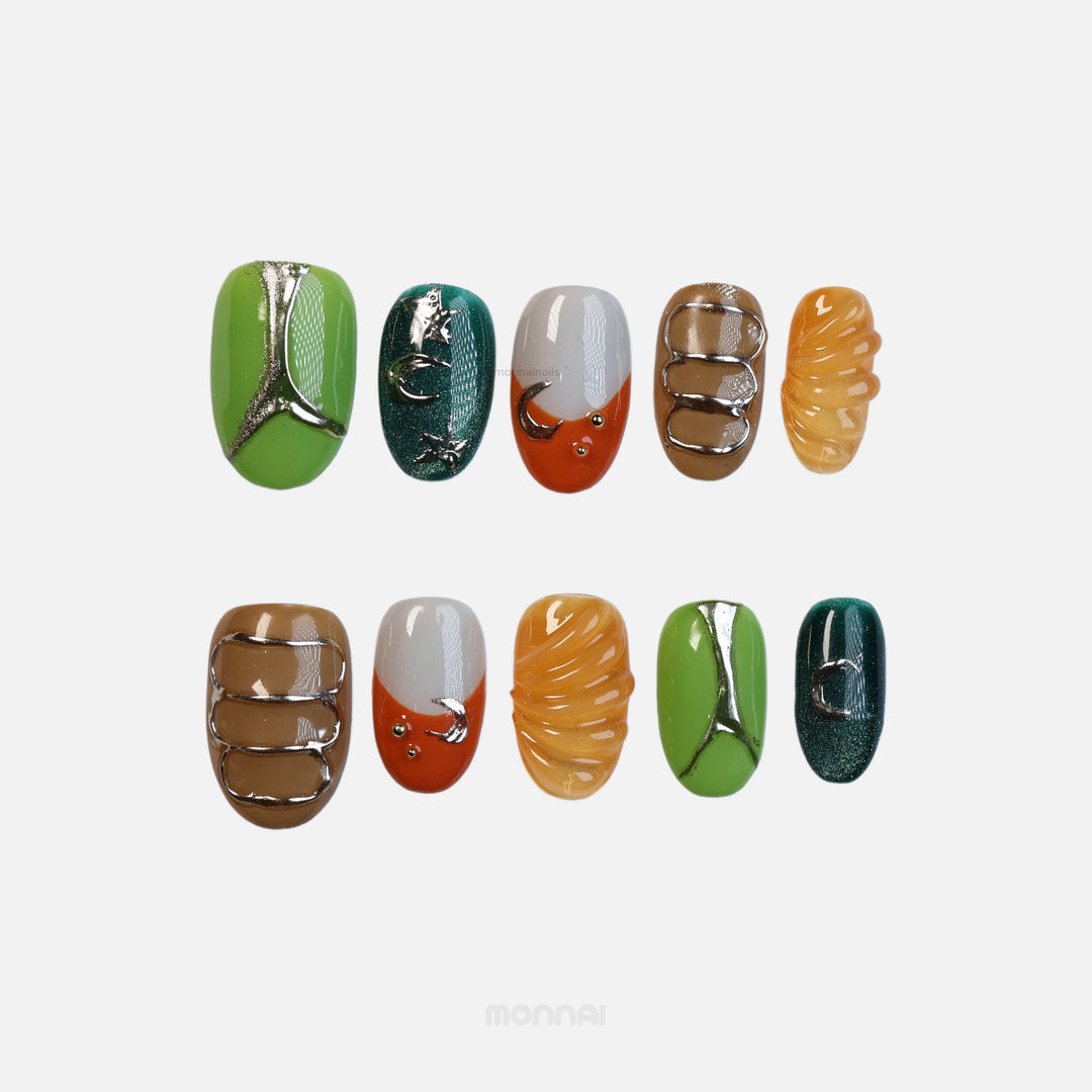 Jungle Glow press-on nails laid out with retro olive green, burnt orange, brown, and chrome accents, sculpted textures.