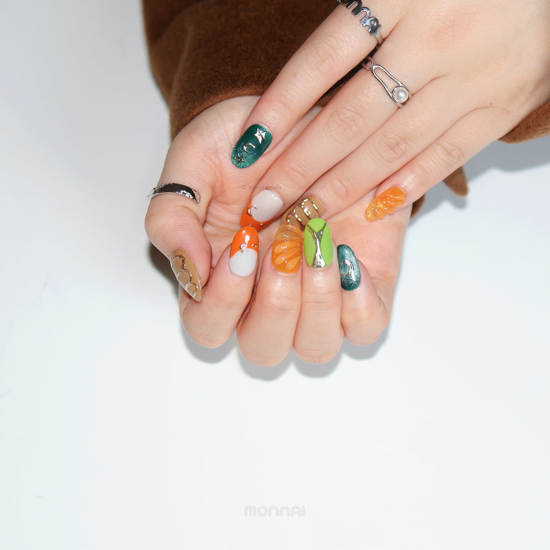 Jungle Glow press-on nails shown on hands, with retro olive green, burnt orange and chrome accents.