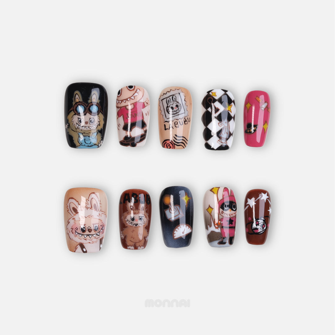 Labubu in Wonderland press-on nails laid out in a mismatched set with glossy hand-painted Labubu cartoon art in nude, black, pink and brown tones.