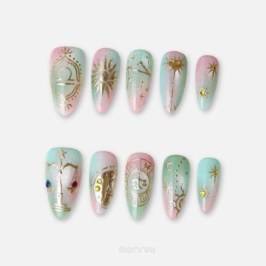Libra press on nails from the Zodiac Collection, featuring pastel pink and mint tones, gold scales, celestial symbols and starry details.