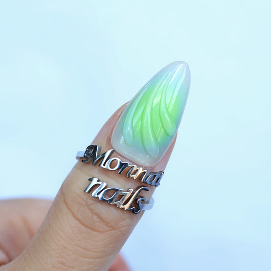 Lime Petals press-on nails on finger, mint green aura base with clear 3D sculpted droplet detail.