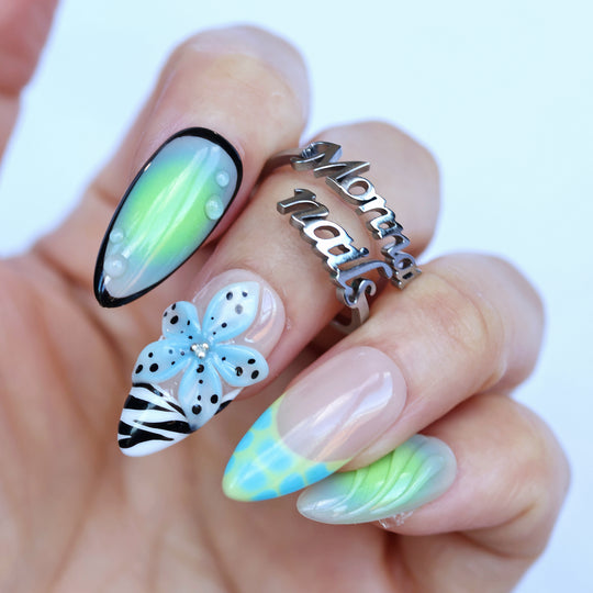 Lime Petals press-on nails on hand with mint aura, 3D blue flower, zebra print and spotted accents
