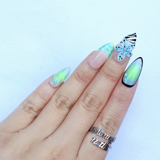 Lime Petals press-on nails on hand, mint green aura tips with 3D butterfly, zebra stripes and dots