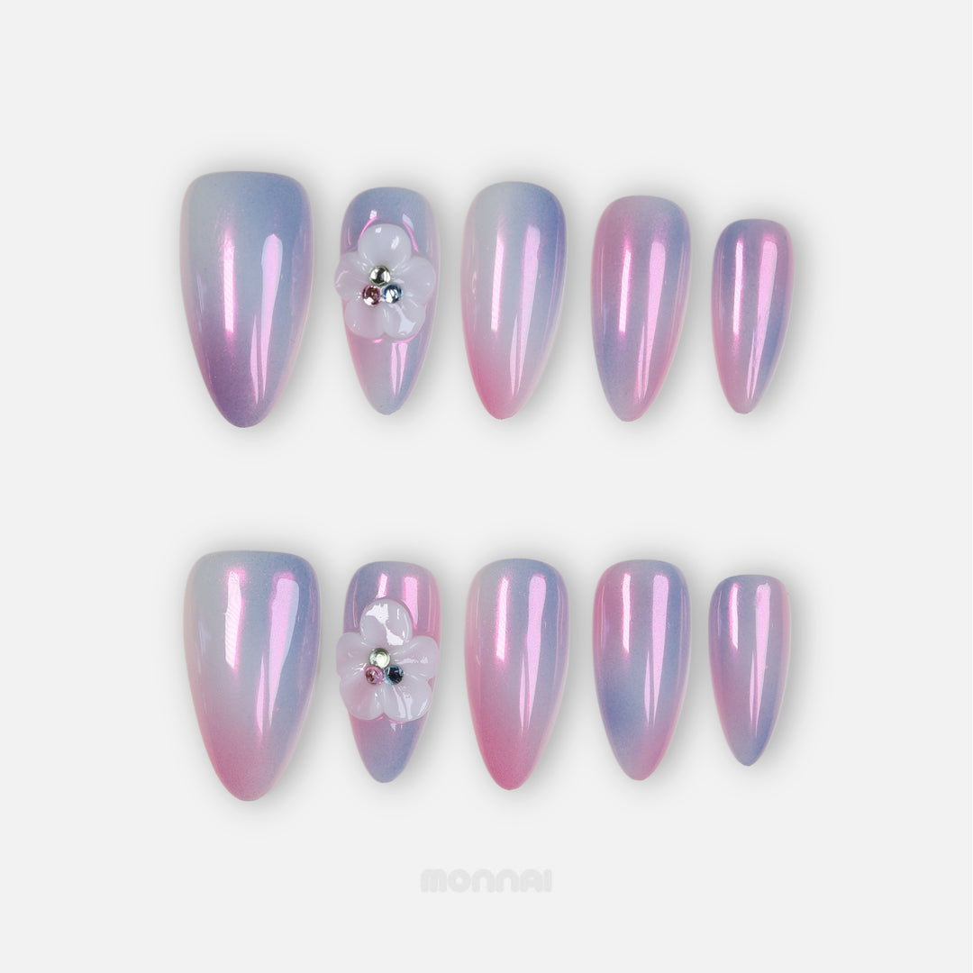 Lost in Petalight press-on nails in pink and lavender chrome, laid out with sculpted floral detail