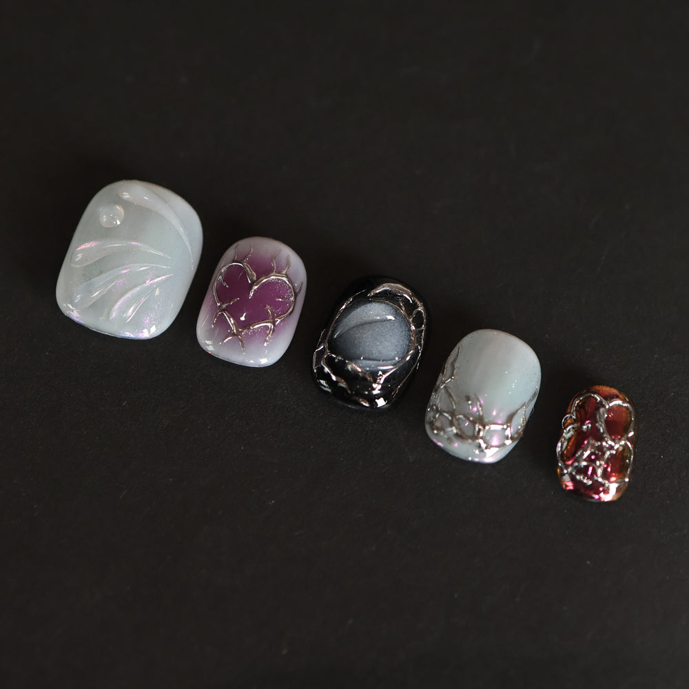 M-Code Cyber-Goth Rebellion press-on nails laid out with purple aura, molten silver chrome thorns, and glossy multichrome accents.