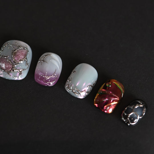 M-Code Cyber-Goth Rebellion press-on nails laid out with purple aura, molten silver thorns, and multichrome accents