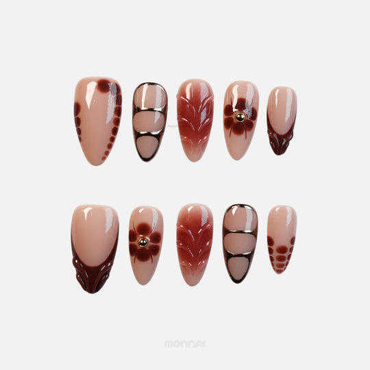 Maple Glow press-on nails with nude base, rich brown accents, floral details, and glossy vintage-inspired linework.