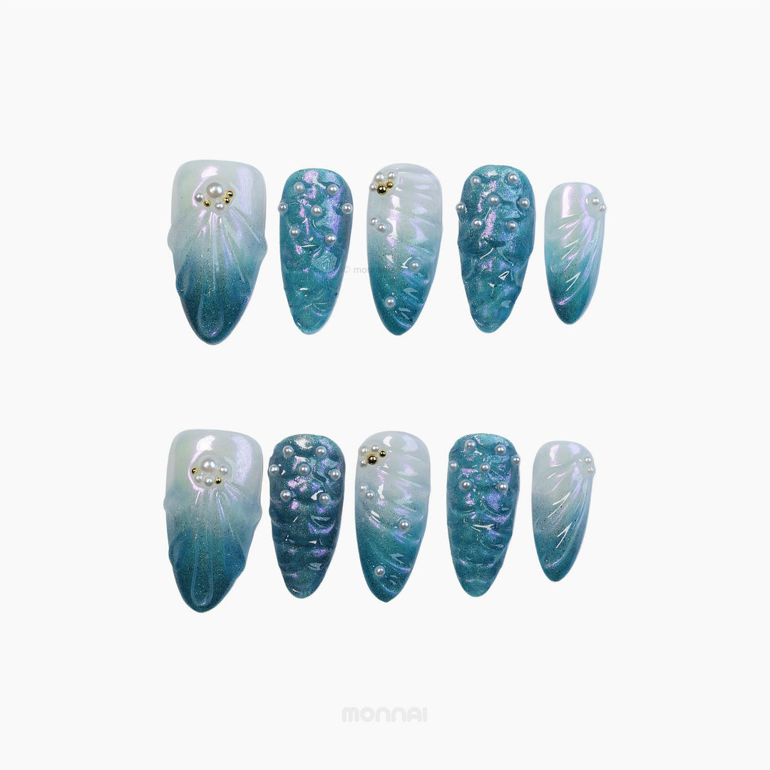 Mermaid's Treasure press-on nails set with teal and pearlescent white gradient, pearls, gold accents, and iridescent shell texture