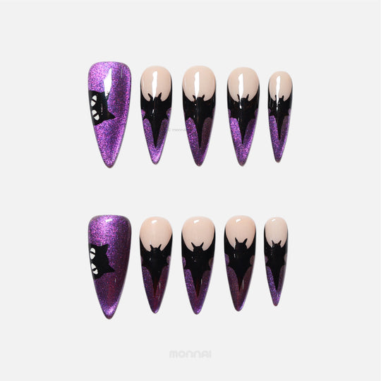 Midnight Bat press-on nails laid out, showing purple cat-eye shimmer, nude base, and black bat silhouettes.