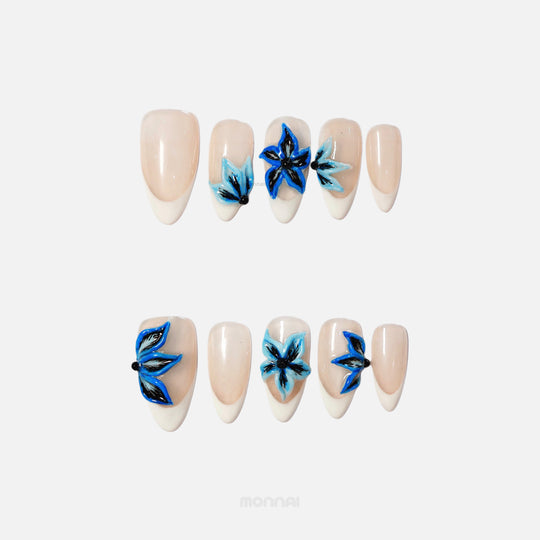 Midnight Petals press on nails featuring electric blue floral design on milky white tips.