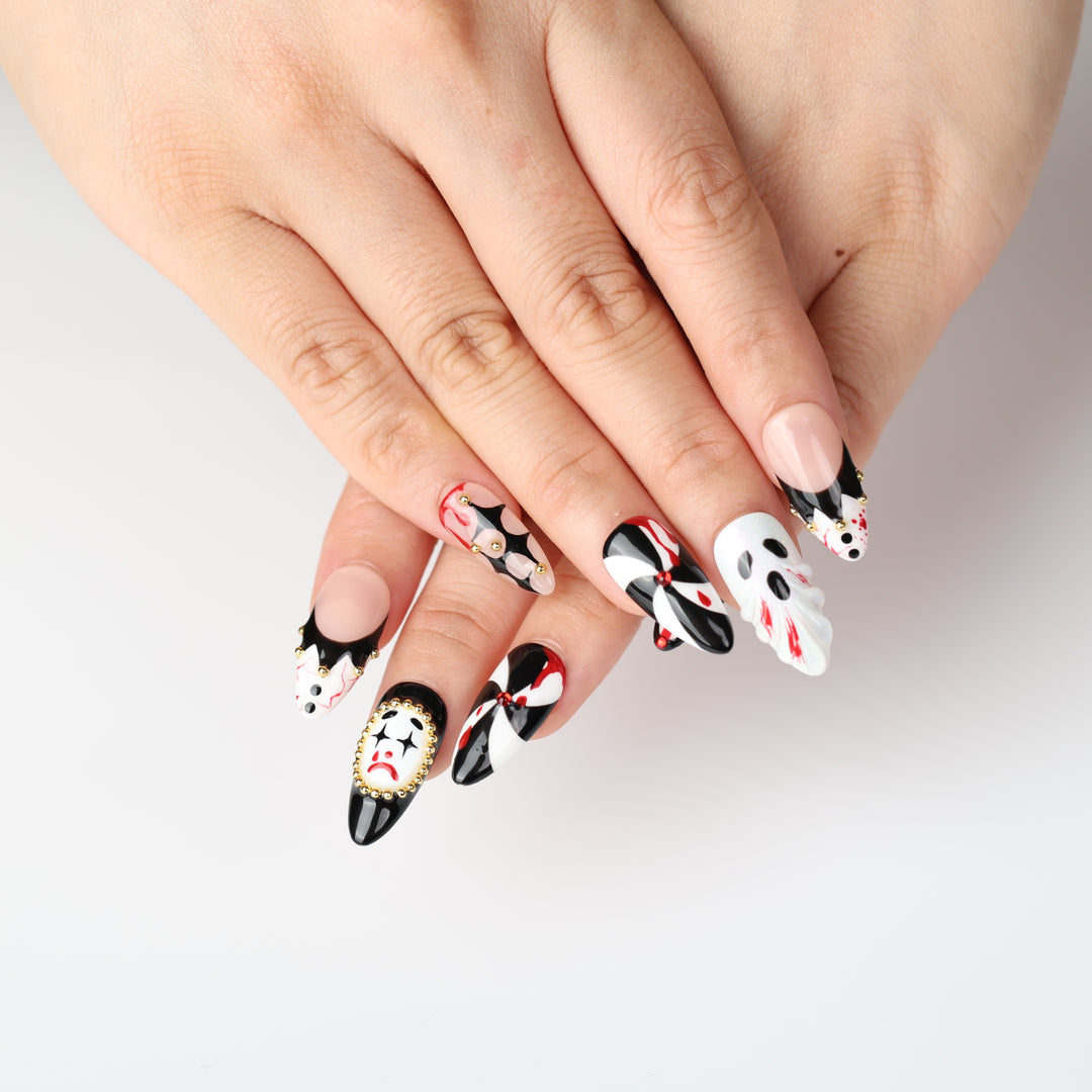 Midnight Marionette press on nails with gothic carnival clowns, black-white diamonds, red accents and gold beads