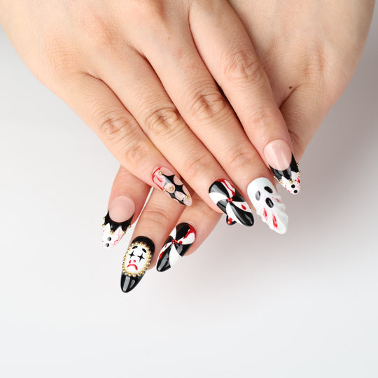 Midnight Marionette press on nails with gothic carnival clowns, black-white diamonds, red accents and gold beads