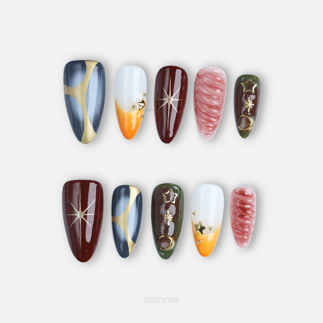 Nocturne press-on nails laid out with moody burgundy, slate blue, olive, nude and gold star-and-moon details.