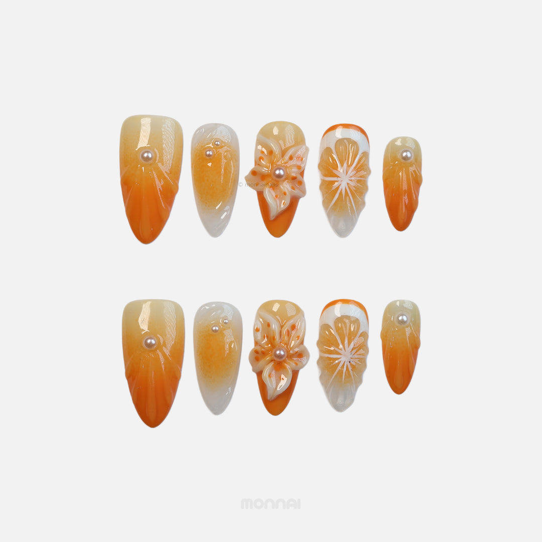 Orange Blossom press-on nails laid out in orange and white citrus floral art with 3D flower details